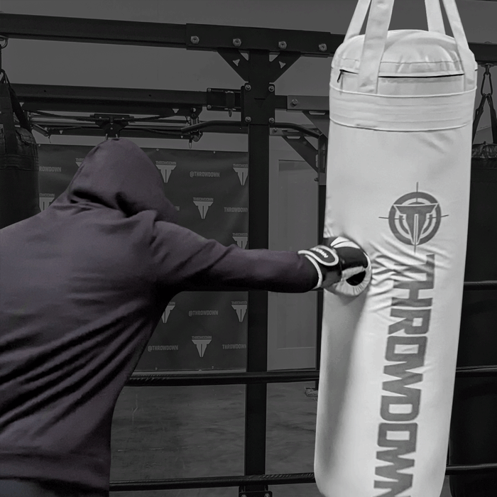 4 Ft White Heavy Bag | Throwdown | Hung display | On included clips | Boxing bag | In use